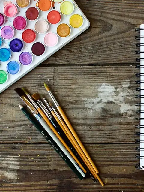 A watercolour palette and brushes