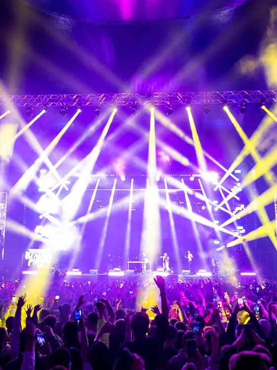 A concert light show over a crowd