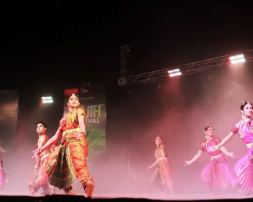 A classical dance troupe on stage